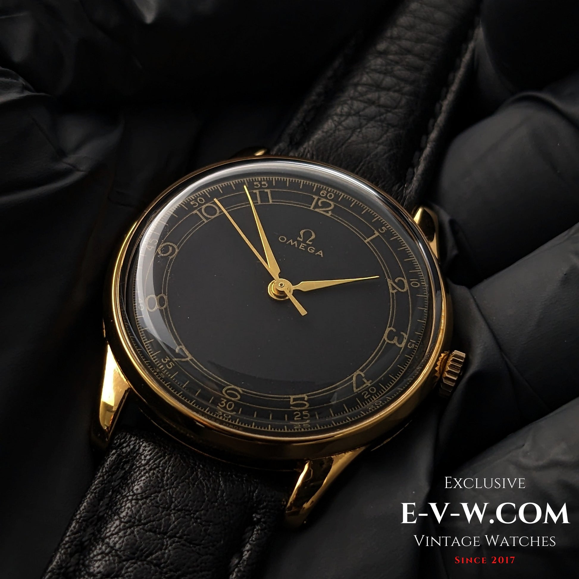 Vintage Omega WWII Gold Watch 1944 with black and gold sector dial, displayed on black leather strap for luxury timepiece collectors.