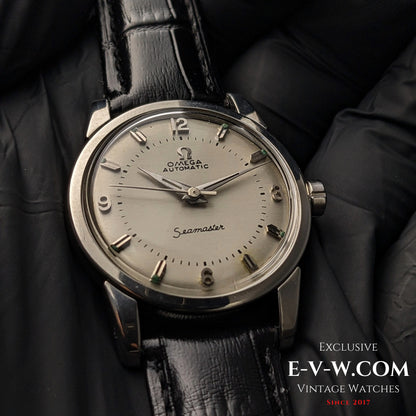 Detailed shot of Vintage 1958 Omega Seamaster Automatic Watch on black gloves, emphasizing dial texture and hour markers.