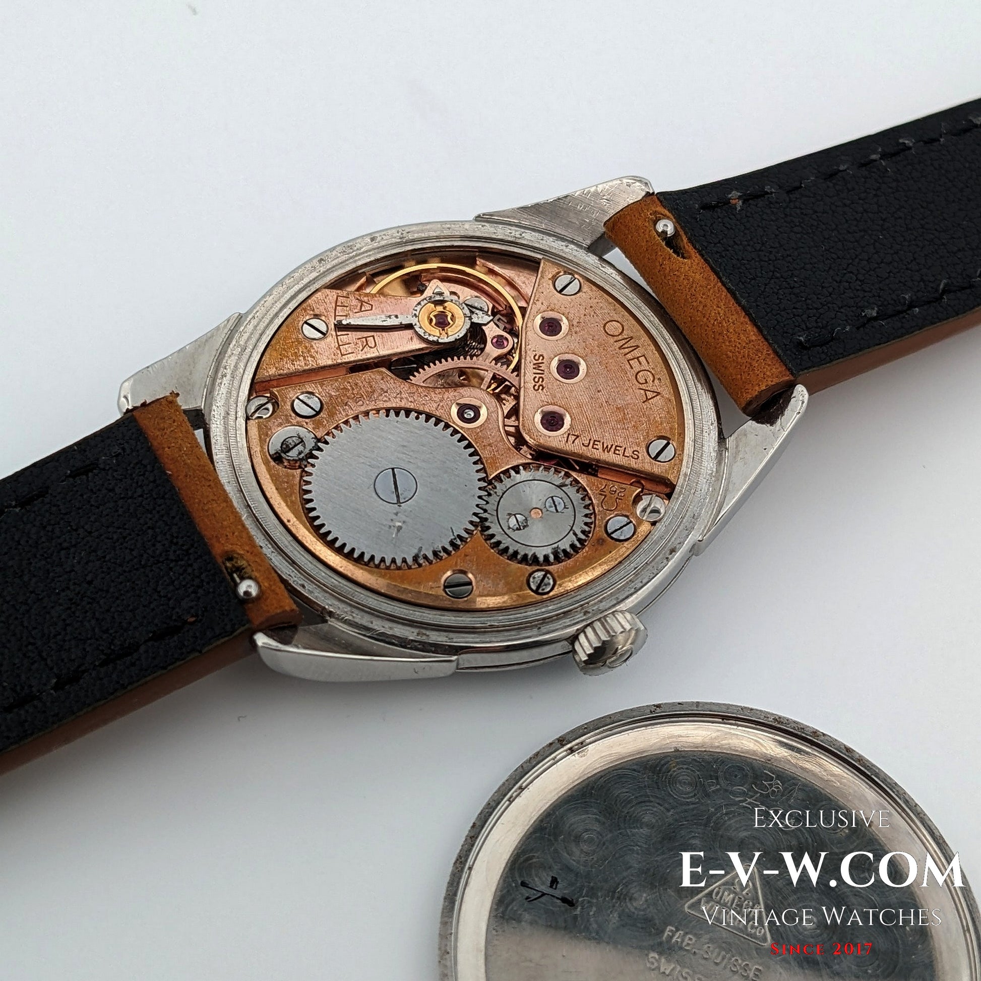Close-up of a vintage Omega watch with visible mechanical components on a white background. 70 Years old Omega Vintage | Ref. 2900-1 | Cal 267 (30T2) | Vintage 1956 | Serviced