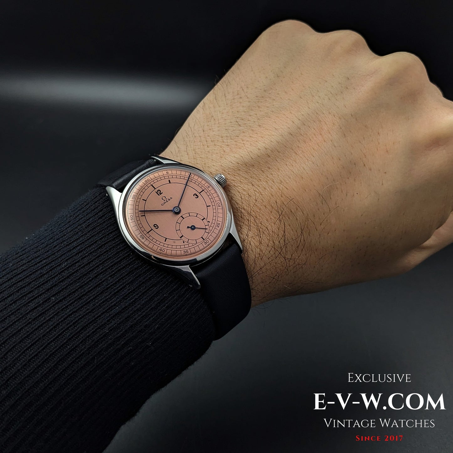 Omega Vintage 1952 Jumbo Ref. 2505 wristwatch worn on wrist, featuring a salmon sector dial and black leather strap.