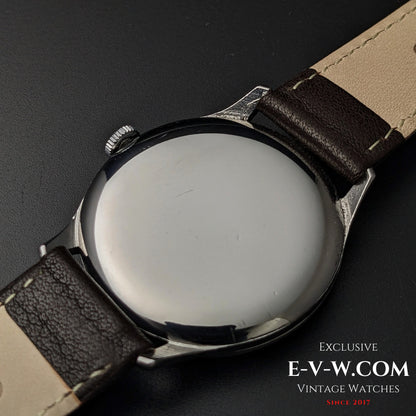 Back view of 1955 Longines Jumbo Calatrava Ref 2849 showing polished stainless steel case and brown leather strap.