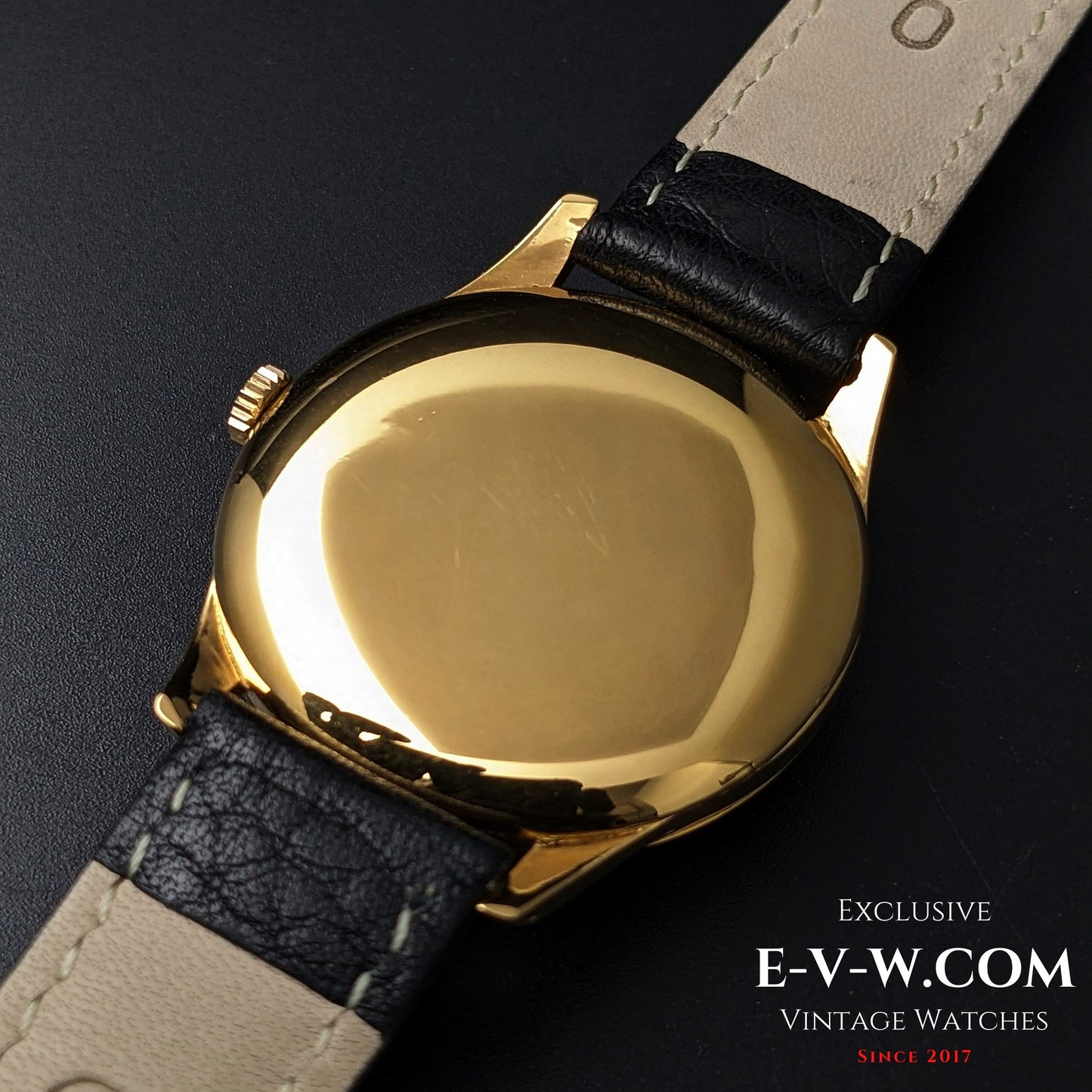 Back view of 1944 Vintage Omega WWII Gold Watch showing polished gold-plated case and black leather strap, ideal for vintage style lovers.