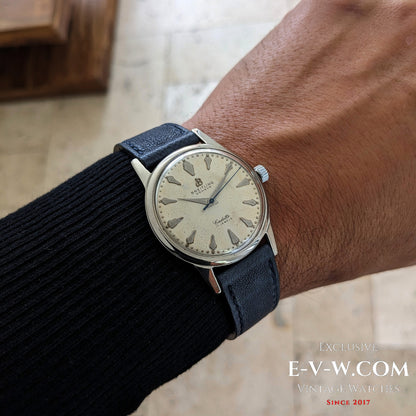 Wrist shot of Vintage Breitling Geneve Cadette Watch 1960s paired with black sweater, showcasing its timeless and elegant design.