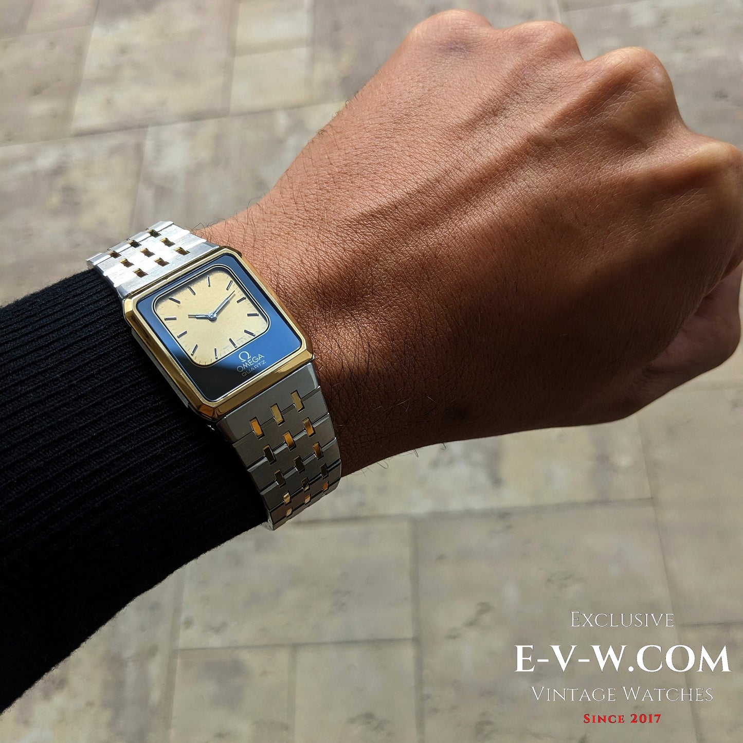 Omega Equinoxe Reverso 1982 vintage watch on wrist, showcasing its sleek square case and two-tone bracelet for a refined retro look.