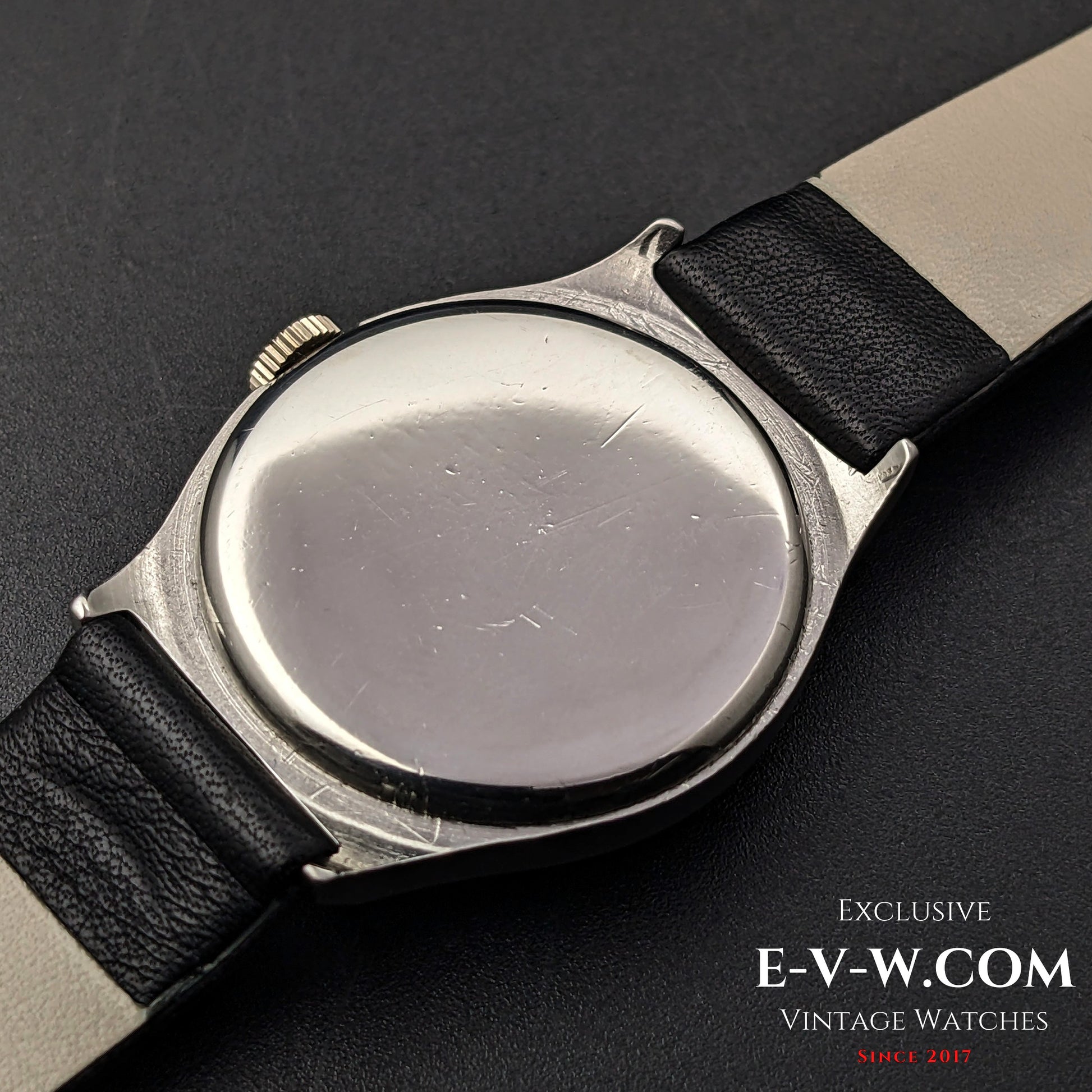 Back view of the vintage Omega wristwatch, showing the stainless steel case with minor scratches, indicative of its 89-year-old history.