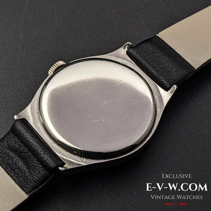 Back view of the vintage Omega wristwatch, showing the stainless steel case with minor scratches, indicative of its 89-year-old history.