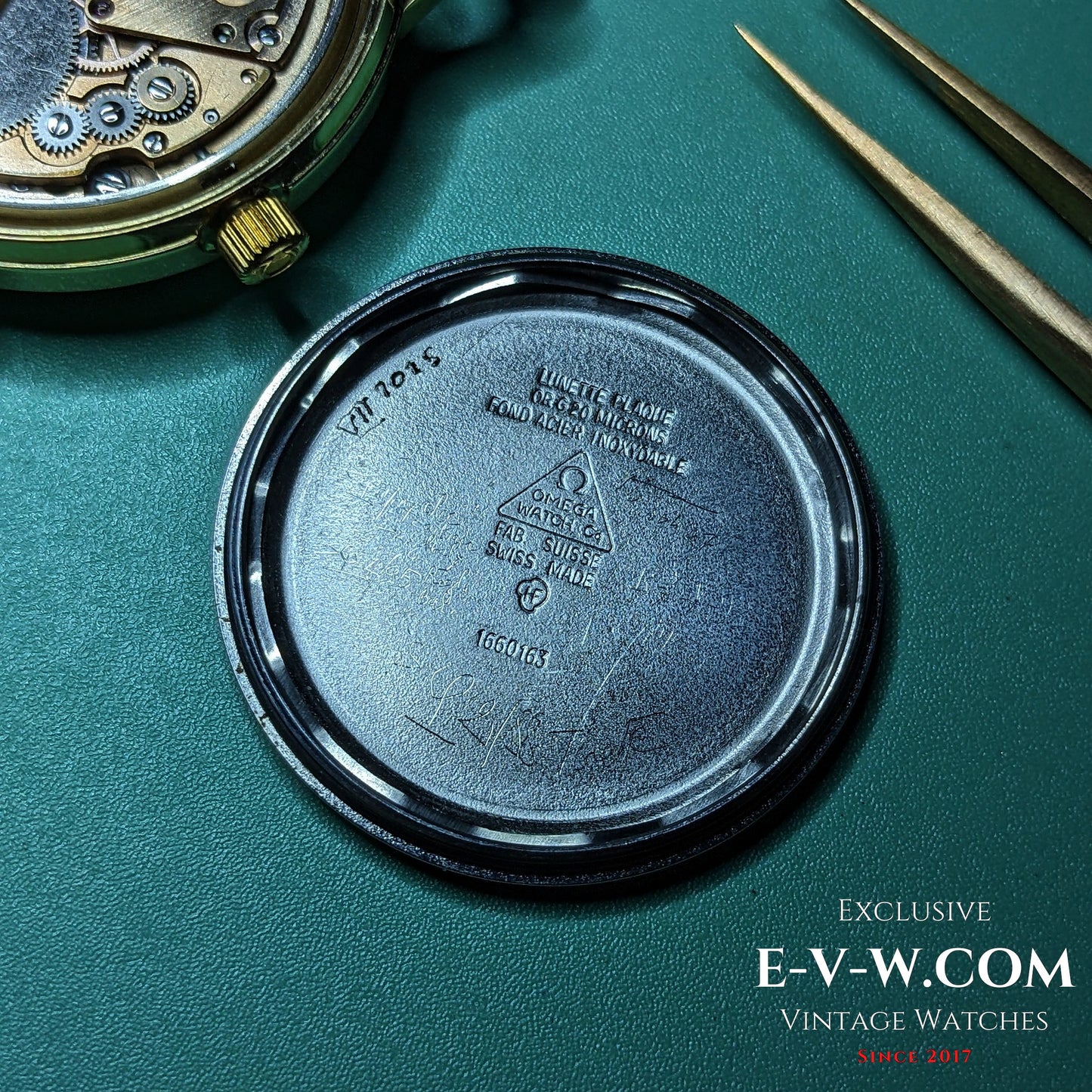 Inside case back of Omega Geneve 1973 Watch Ref. 1660163 showing reference number and Swiss hallmark, confirming authenticity.