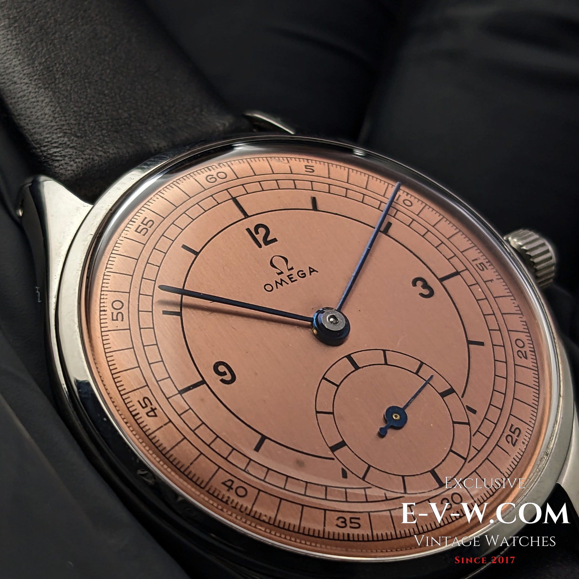 Macro shot of Omega Vintage 1952 Jumbo Ref. 2505 wristwatch, highlighting the intricate salmon sector dial design.