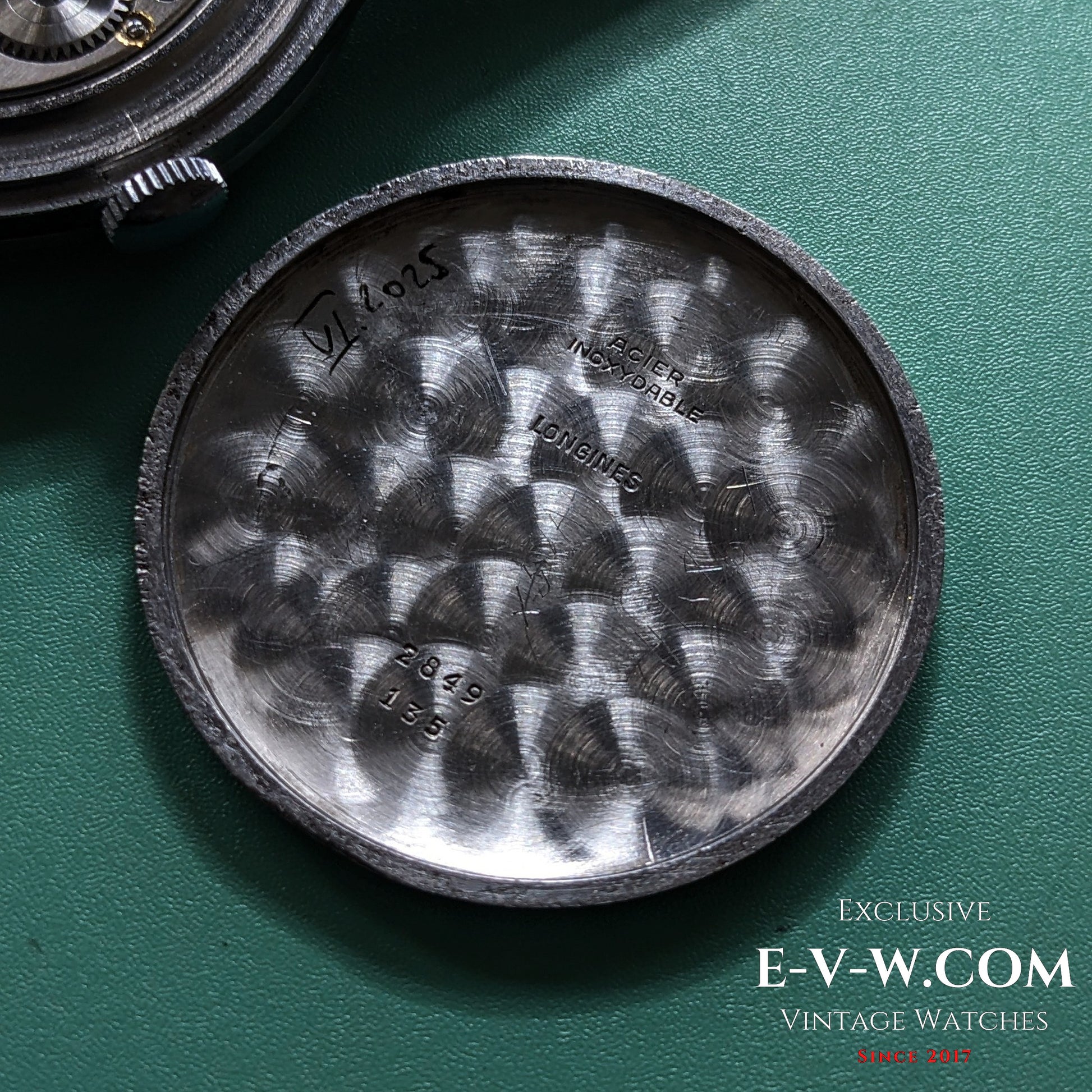 Inside case back of 1955 Longines Jumbo Calatrava Ref 2849 showing reference number and vintage engravings for authenticity.