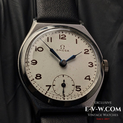 Close-up of the Omega Art Deco wristwatch dial, featuring a silver-tone face, blue hands, Arabic numerals, and a small seconds subdial.