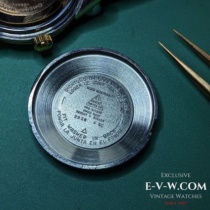 Inside case back of Omega Seamaster 2828-9SC showing reference number and Swiss manufacturing engravings on brushed steel surface.