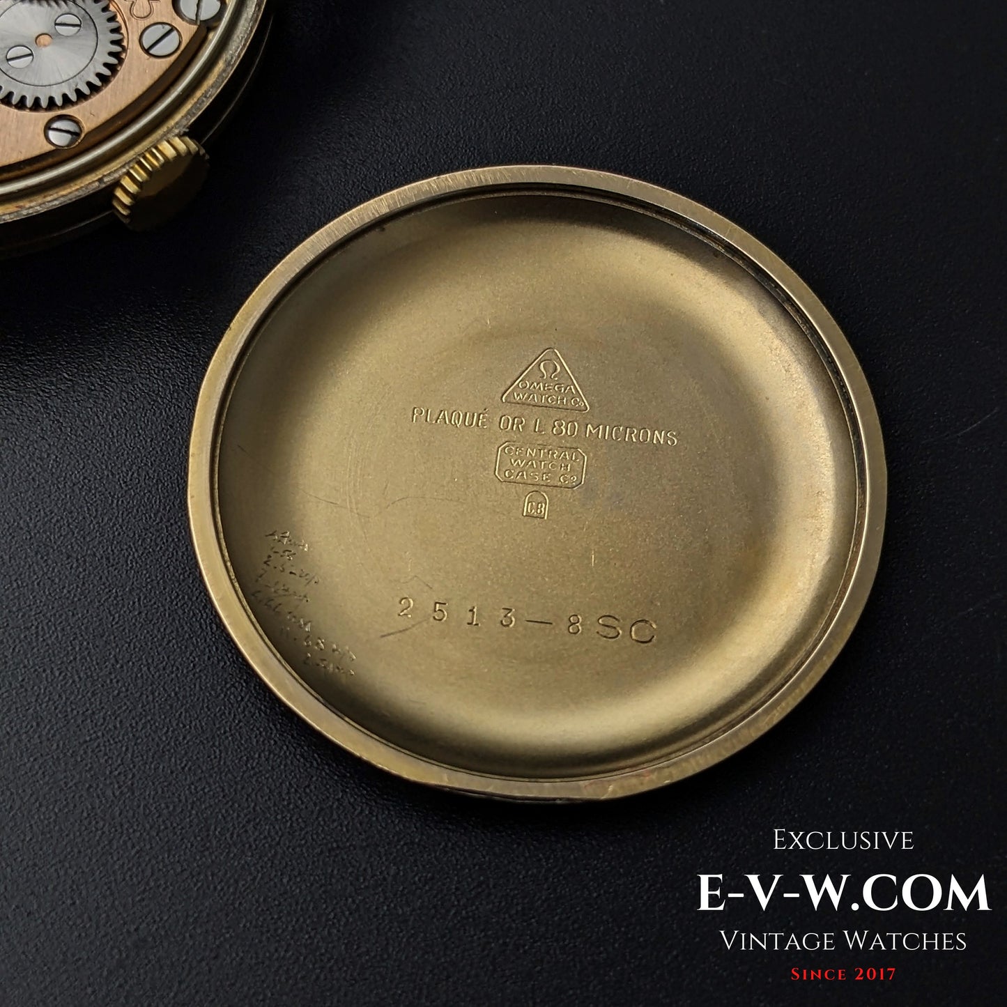 Inside case back of the Vintage Omega Classic Gold Plaque watch, engraved with reference number 2813-8SC and gold plaque details.